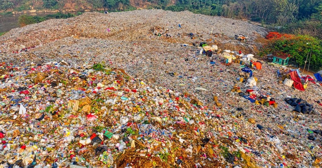 A high-angle view of a vast landfill site in South Tangerang, Indonesia, showing environmental impact.