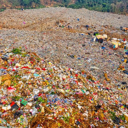 A high-angle view of a vast landfill site in South Tangerang, Indonesia, showing environmental impact.