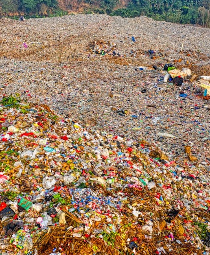 A high-angle view of a vast landfill site in South Tangerang, Indonesia, showing environmental impact.